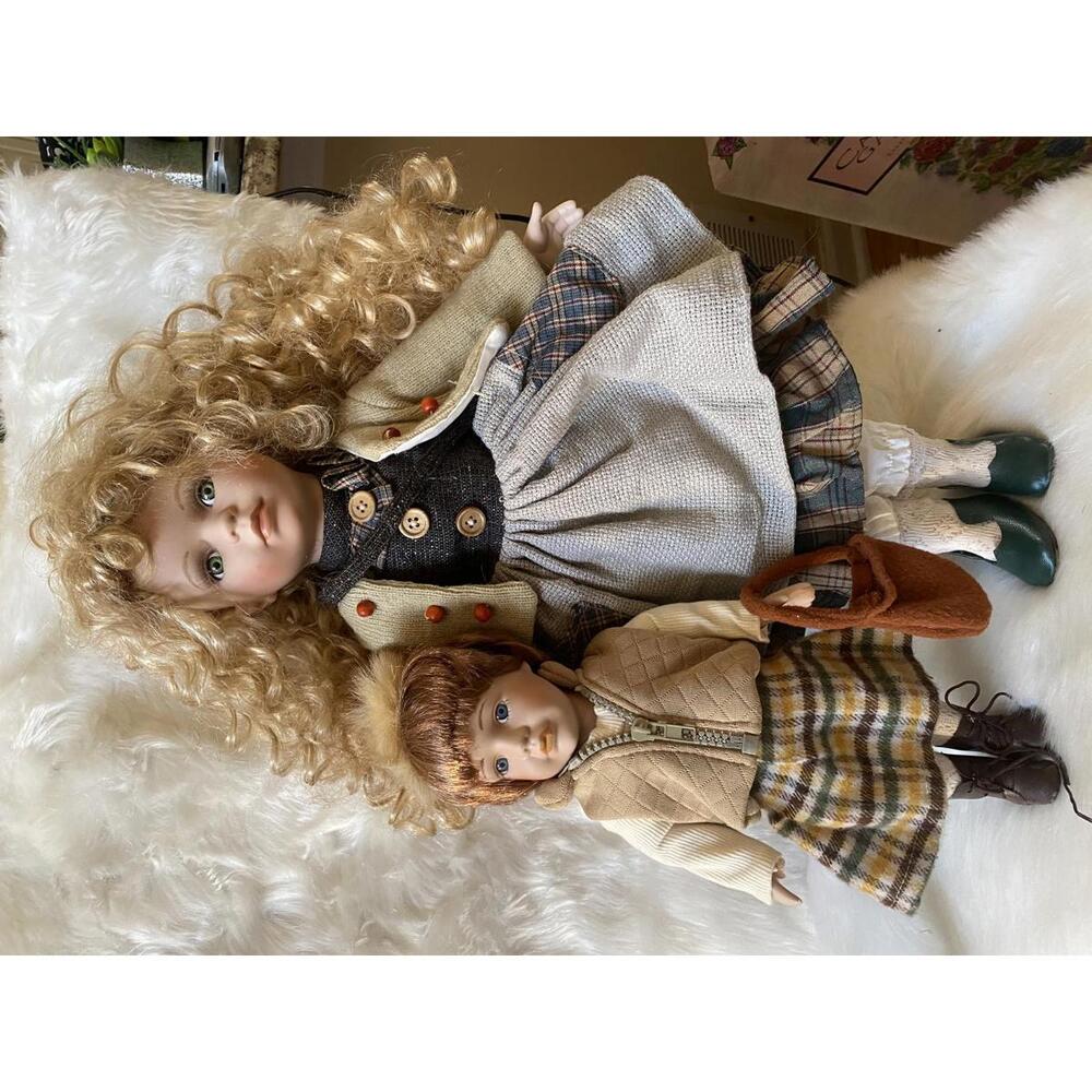 Pair of Vintage Porcelain Dolls with Detailed Clothing